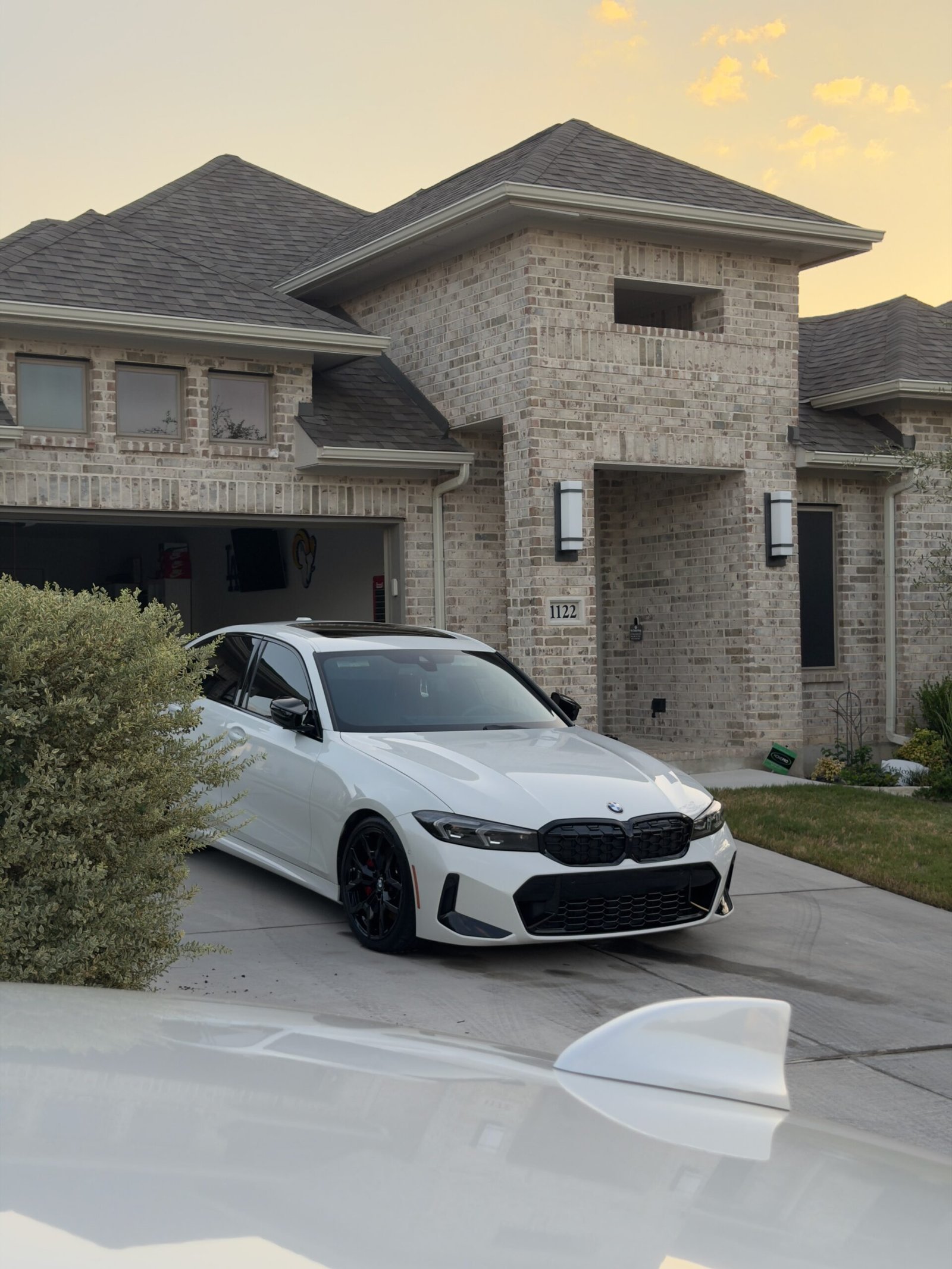 White BMW 3 Series detailed in a San Antonio driveway